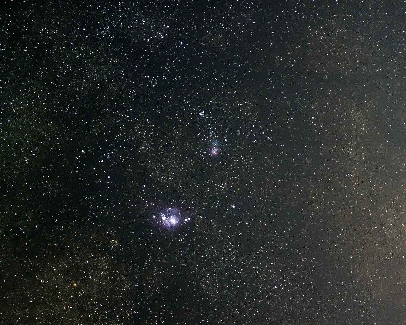 The Lagoon and Trifid nebulae, M8 and M20, in a dense Sagittarius star field