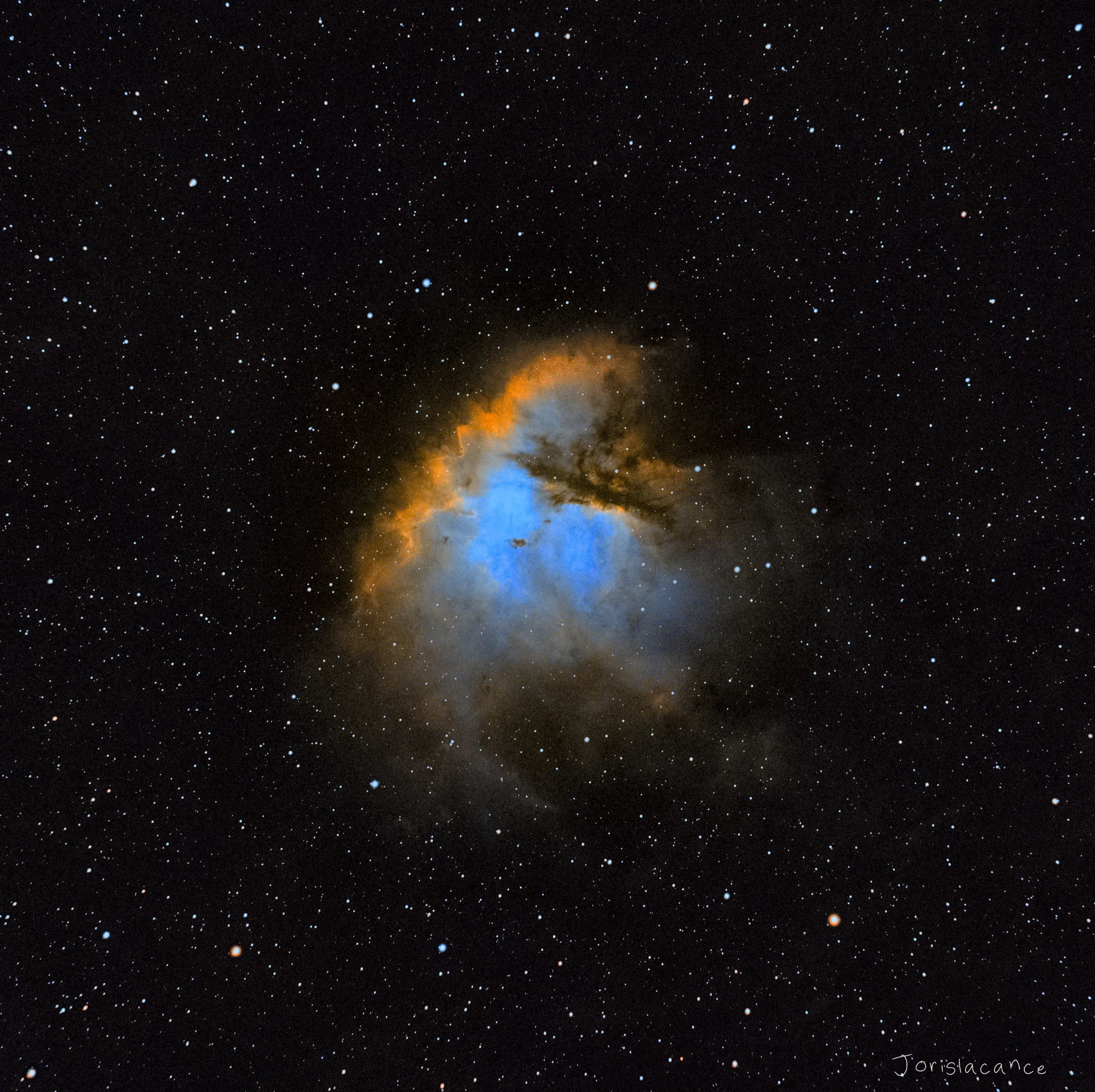 The Pacman Nebula, NGC 281, in the Hubble palette, a dark dust lane cutting into the glowing gas